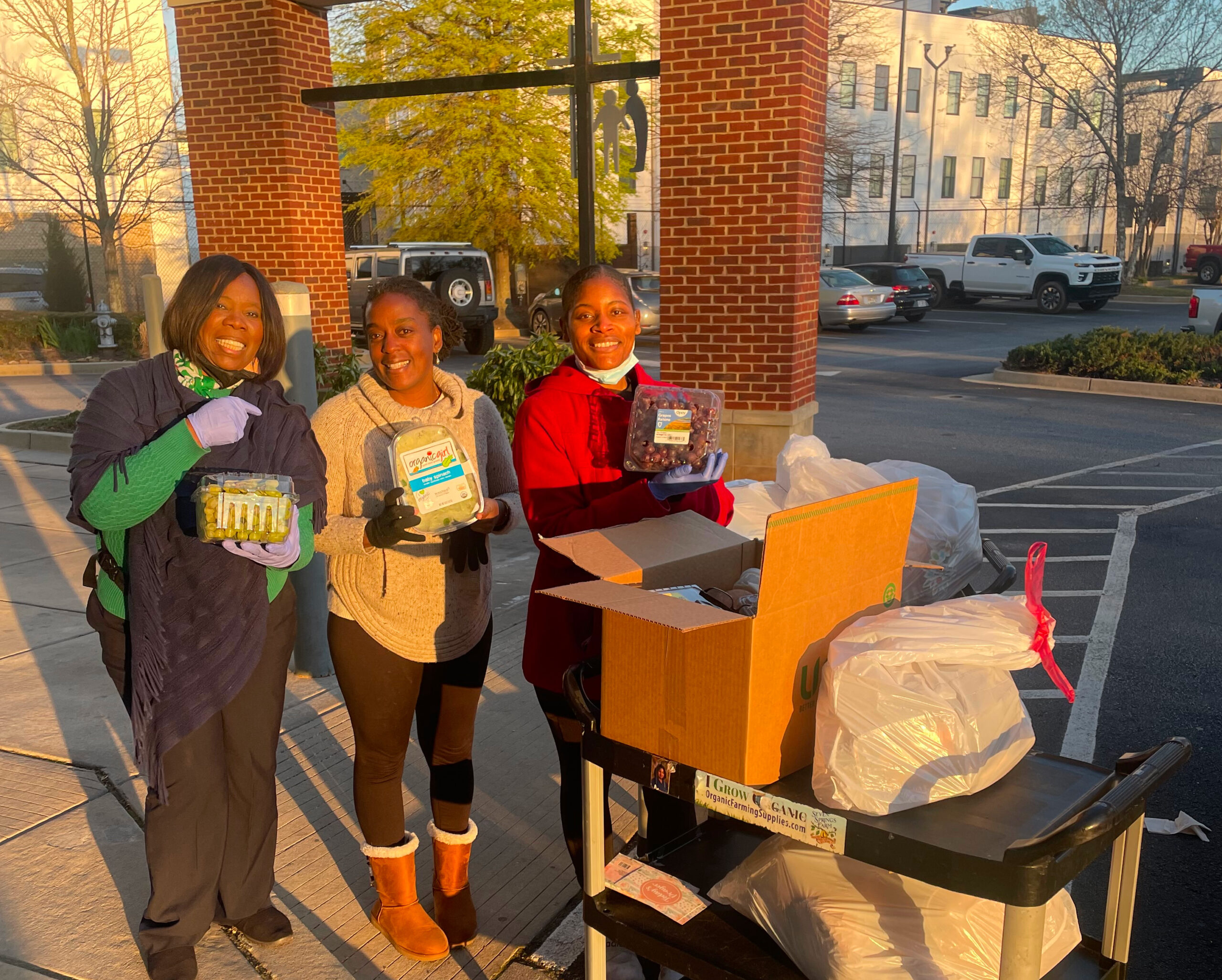 Loren Ferguson, Audrey Clark and SHA volunteer unloading donations from Whole Foods Buckhead